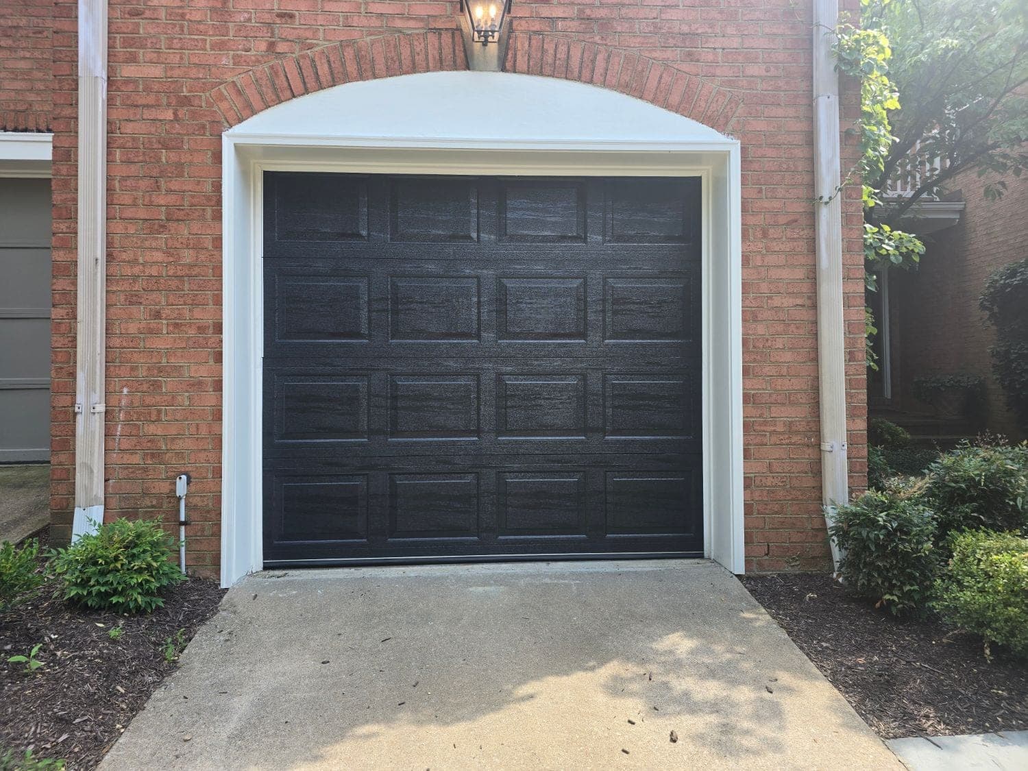 Bold black raised-panel door installed by GarageWiz in Rockville, MD