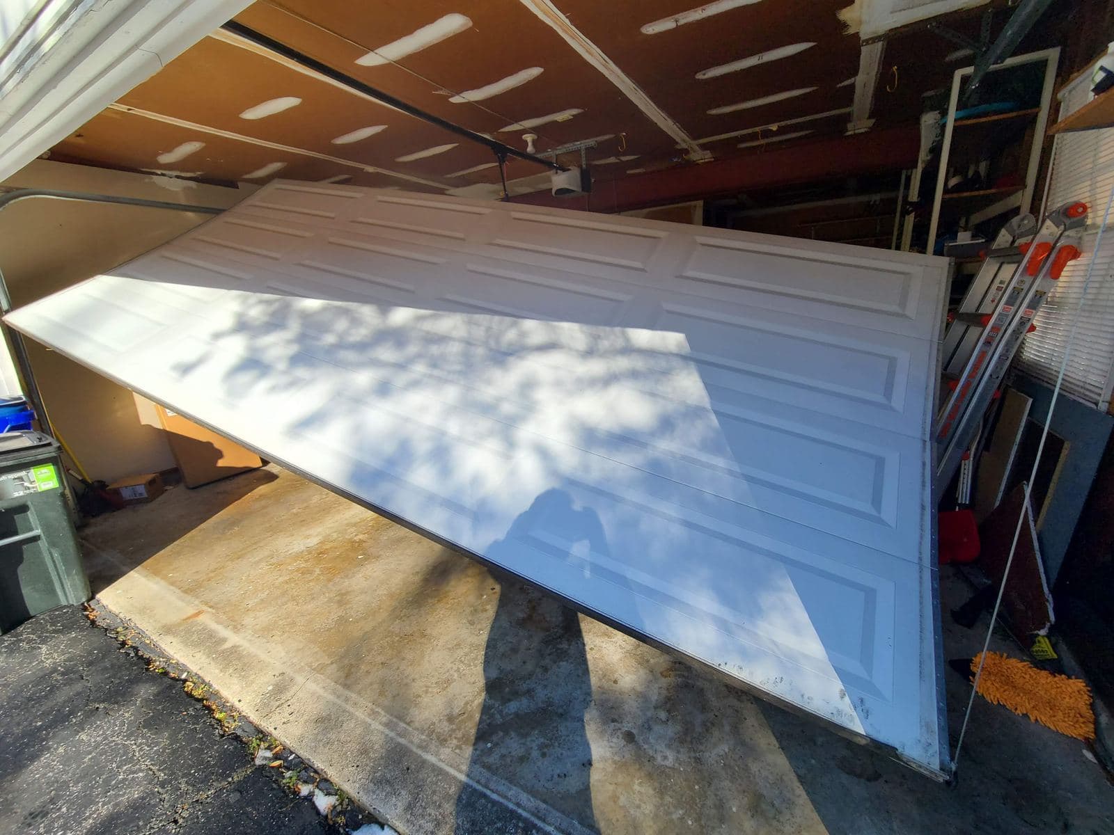 Garage door pulled off its tracks inside a garage